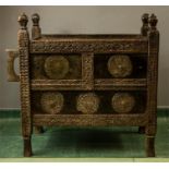 An antique Indian Damchiya hope chest, carved profusely and having four carved finials/handles to