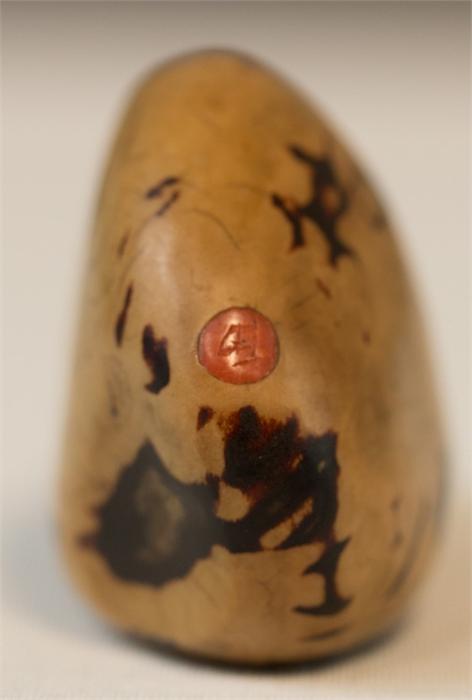 A Chinese carved bottle, polished nut bearing an inlaid coral tag engraved with calligraphy, and a