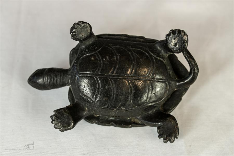 A dark patinated cast metal tortoise.