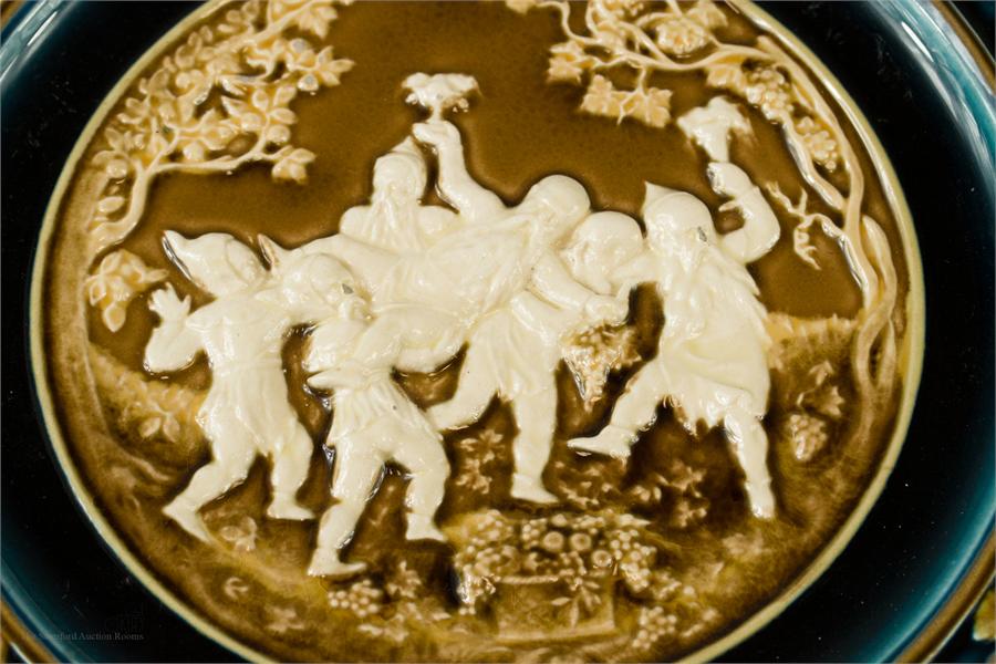 An Austrian majolica relief moulded charger, no 540 impressed to the base, 32cm diameter. - Image 2 of 2