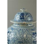 A late 18th/early 19th century Chinese jar & cover, decorated with blue and white foliage, 45cm