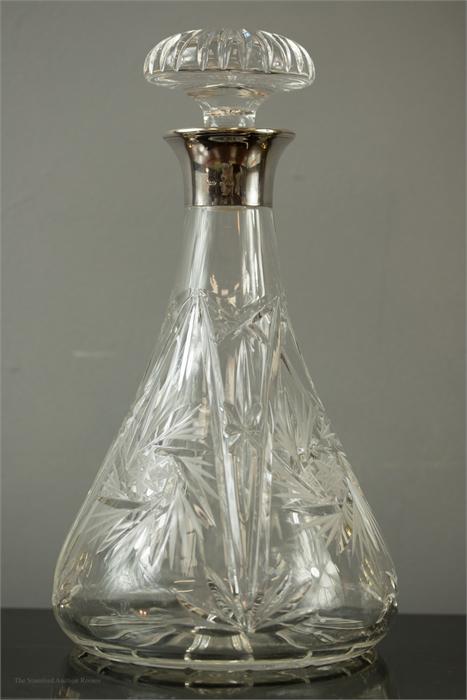 A crystal decanter with silver collar, London 1992, with original stopper.
