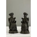 A pair of bronze Chinese figures; Emperor and wife.