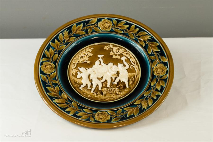 An Austrian majolica relief moulded charger, no 540 impressed to the base, 32cm diameter.