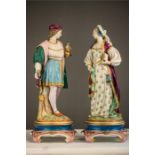 A pair of Victorian porcelain figures of a man and woman in period attire, possibly German.