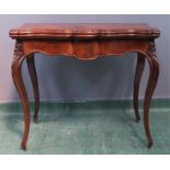 A late 19th/early 20th century mahogany card table with serpentine top above cabriole legs.
