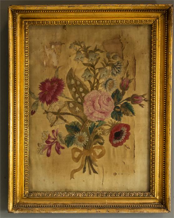 A 19th century needlework panel depicting a floral group with rose to the centre, 38 by 27cm.