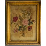 A 19th century needlework panel depicting a floral group with rose to the centre, 38 by 27cm.