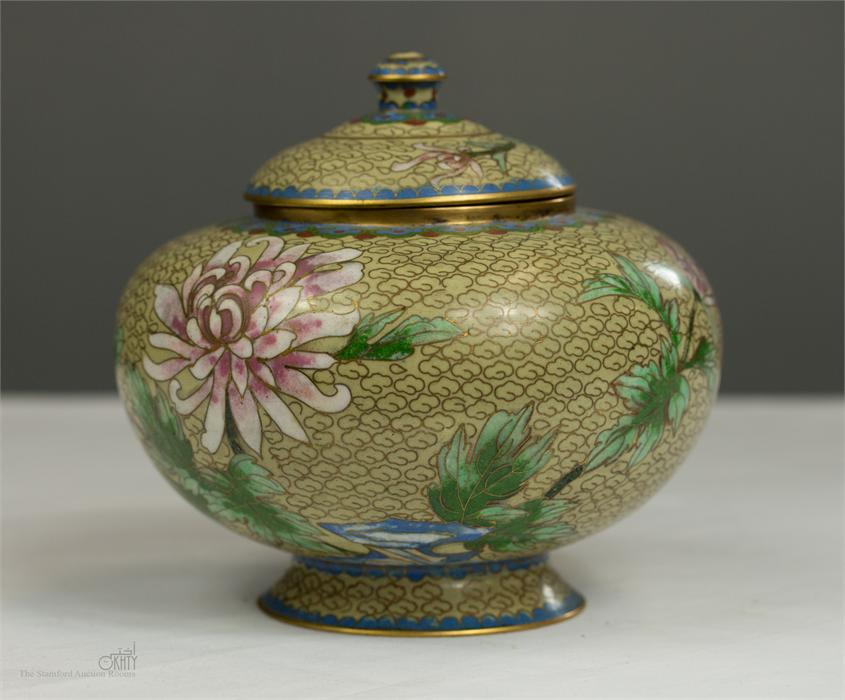 A Cloisonne jar and cover depicting peonies.