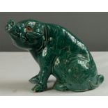 A majolica style green stoneglazed pig with glass eyes.