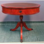 A modern drum table, with green leather top, two drawers and tripod base.