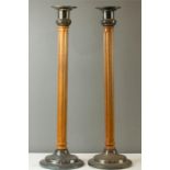 A pair of oak and silver plated tall candlesticks with fluted stems.