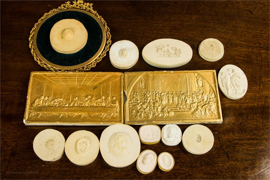 A group of plaster cast intaglios, gilt metal frame, plaster relief friezes, etc.