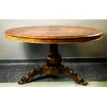 A 19th century mahogany circular top breakfast table, with lobe carved collar raised on three scroll