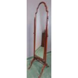 A mahogany cheval mirror, with shaped top and finial surmounts.