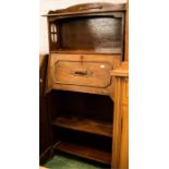 An oak hall stand/secretaire with pierced sides.