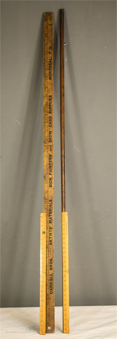 A group of rules and measuring sticks, including a Rabone dipstick.