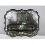 A 19th century black lacquered papier mache inkwell, with mother of pearl inlaid decoration and