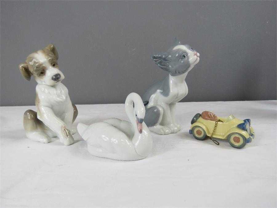 Lladro: four figurines; cat, New Friend, Elegant Swan and Little Roadster.