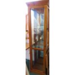 A pine glazed display cabinet, with mirrored back and glass shelves.