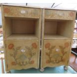 A pair of French style of bedside tables, painted with flowers and raised on bun feet.