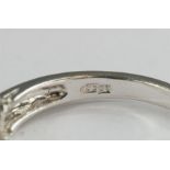 A white gold (unmarked) and diamond ring, size N, 2.9g.