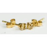 A pair of 18ct gold and diamond earrings, the round brilliant cut diamonds in a claw setting,