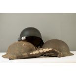 A WWI Brodie Helmet shell with remains of leather strap, a WWII 1939 dated British Soliders Tommy