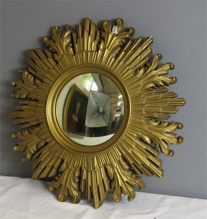 A giltwood starburst mirror, with convex circular mirror to the centre.