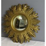 A giltwood starburst mirror, with convex circular mirror to the centre.