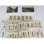 A quantity of cigarette card sets and early 20th century postcards.