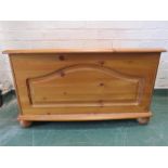 A pine blanket box with panel front.