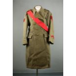 An Army overcoat, with Kings Crown, Sergeants sash and brass badges.