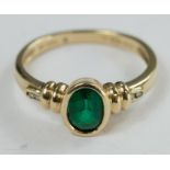 A 9ct gold ring with synthetic green emerald, size M, 2.2g.