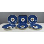 A group of Wedgwood with powder blue ground bordering basket and fruit decoration; seven dishes,