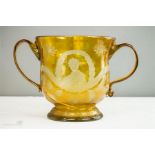 An 18th century yellow glass twin handled bowl, dated 1745 and engraved with portrait of Bonnie