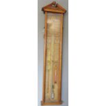 An Admiral Fitzeroys Barometer, 1892 in an oak case with carved split pediment top, the glazed front