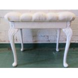 A white painted stool with cabriole legs, and buttoned seat.
