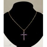 An 18ct chain, 2.09g with a 9ct gold cross pendant set with amethyst and chip diamonds, 1.8g.