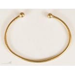 A 9ct gold torc bangle, 21.8g.