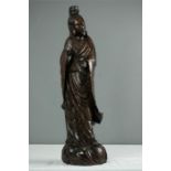 A Chinese hardwood carved figure of a Guanyin with silver inlaid decoration.