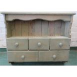 A painted pine wall rack with five drawers.