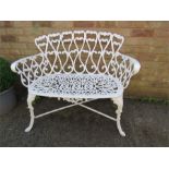 A white painted cast iron two seater garden bench.