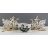 A pair of German ceramic pot pourri holders in the form of cherubs, and a 19th century tea cup.