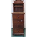 A four drawer mahogany cabinet with raised and carved back.