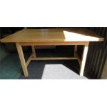 An extending beech dining table, with square section legs.