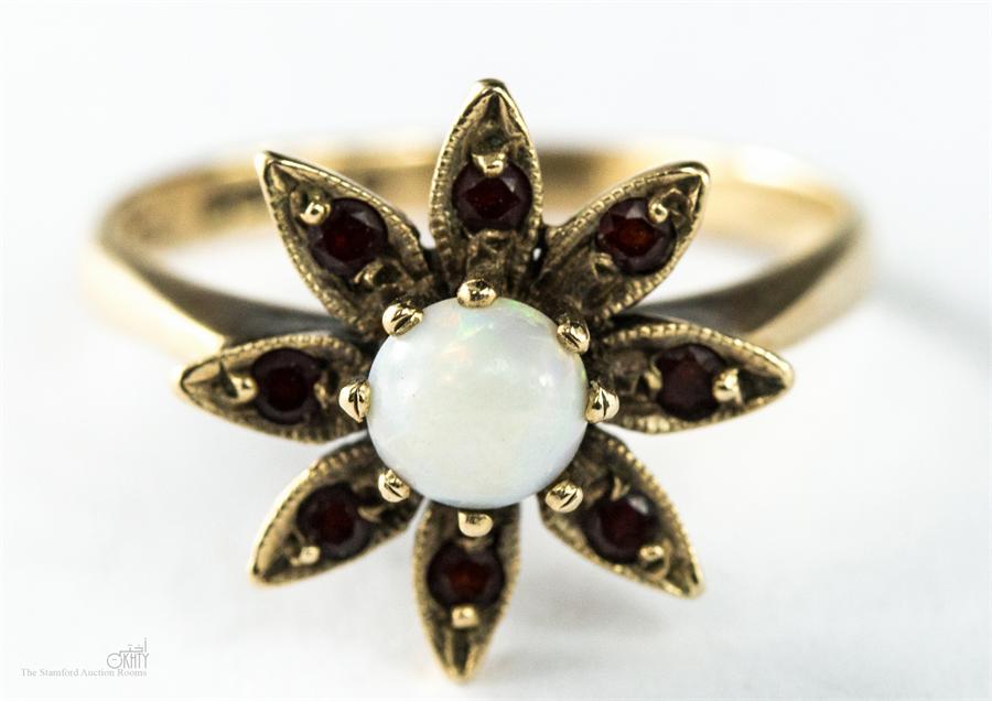 A 9ct gold, opal and garnet flower-head ring, size K/L, 2.5g