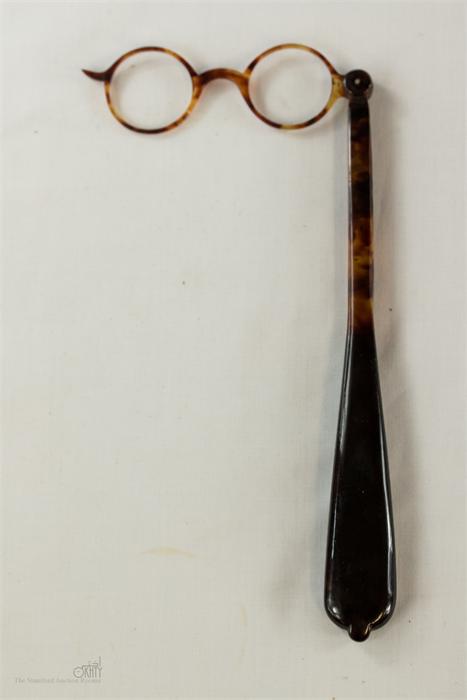 A pair of early 20th century tortoiseshell long handled lorgnettes.