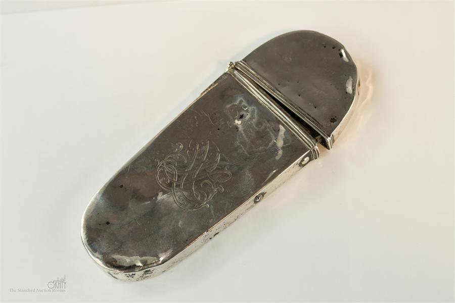 A late 19th century silver flip top spectacles case, engraved with a central motif.