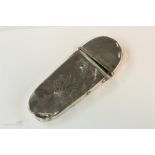 A late 19th century silver flip top spectacles case, engraved with a central motif.